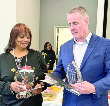 Superintendent Clay Corley presents retirement award to Worlita Jackson after serving the district 26? years.