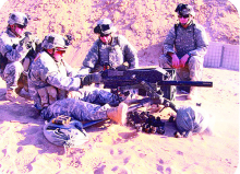 SSG Richard Vazquez is pictured behind a machine gun with members of Special Forces Group while on a tour of duty in Afghanistan. The Green Beret served 3 tours of duty. (Enterprise File Photo)