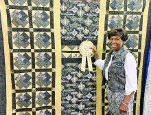 The Viewers Choice Award Quilt - This award goes to Rubinstean Jones, New Orleans Saints quilt she pieced for her saints fan nephew. The quilt was machine quilted by Lorena Pauc.