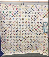 Tabatha Sparks pieced Clementine and Marva’s Leaders and Enders. She used all scraps and many of the colored squares came from her little dog Clementines neck kerchiefs from her groomer Marva. Quilt was machine quilted by Lorena Pauc.