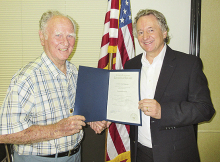 Raymond Powell (on left) is presented a state certicate that honored his service to DeSoto Parish and the State of Louisiana by past Senator John Milkovich.