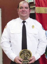 DFD 1 Firefighter Jody Warren shows off an award he received. He passed away in February 2025.