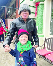 “Topiary” open for business Young and old gather on Village sidewalk awaiting parade.