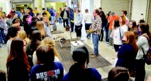 Students from area schools watch the Metal Pour demonstration during NSUʼs Art Extravaganza.
